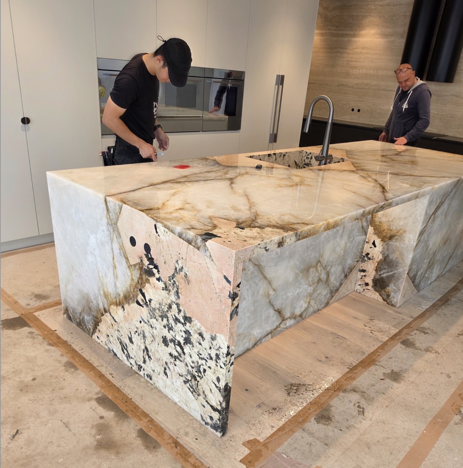 Countertop protection film applied to a marble island bench