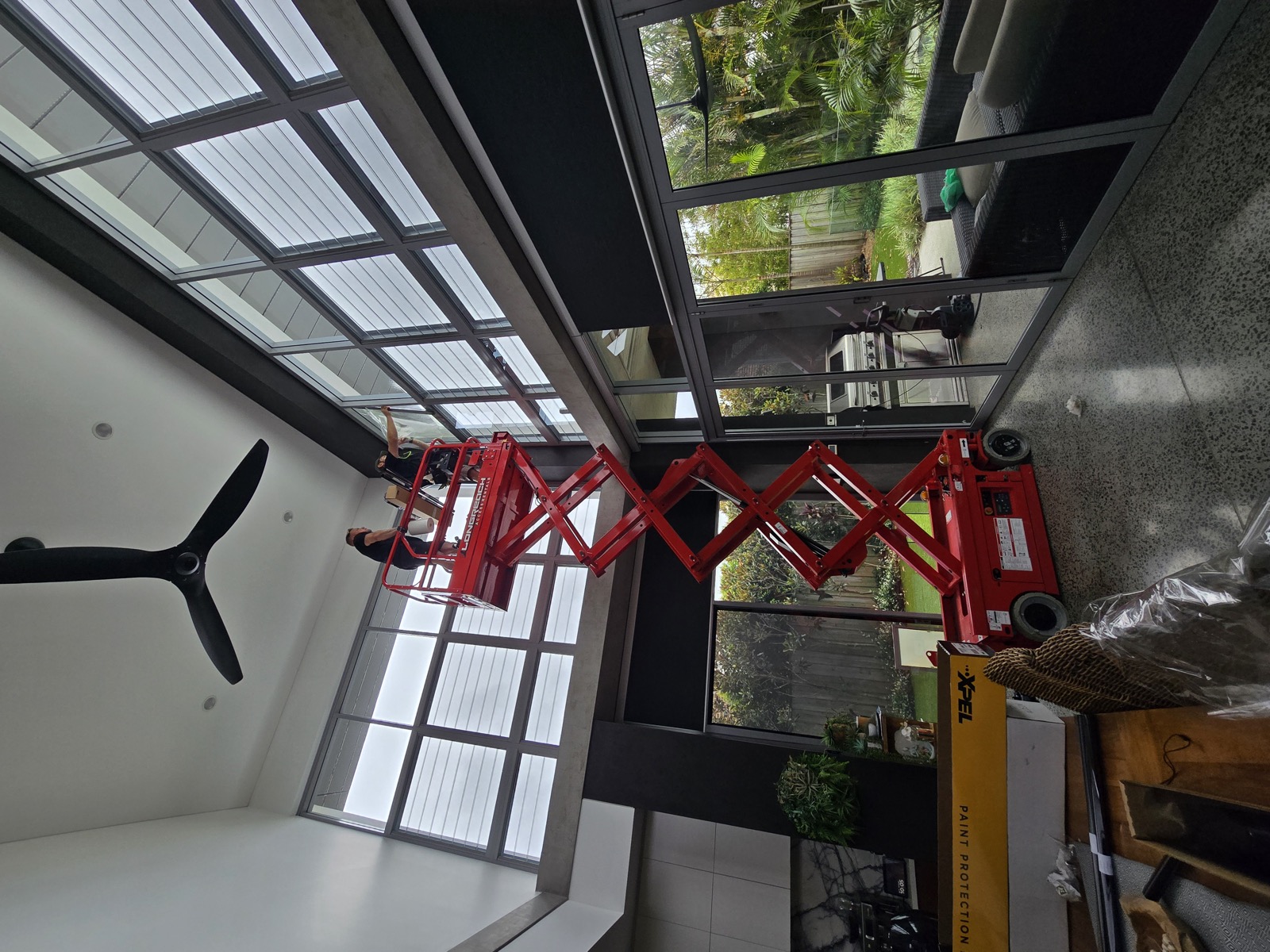 TintCo team tinting double-height commercial windows